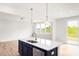 Island kitchen with stainless sink and fixtures adjacent to a living area at 305 Little Creek Dr, Lillington, NC 27546