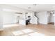 Open floor plan combining kitchen and living spaces with staircase at 305 Little Creek Dr, Lillington, NC 27546