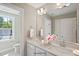 Bright bathroom featuring double sinks with stone countertops and a large mirror at 34 Macy Cir, Wendell, NC 27591