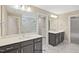 Contemporary bathroom featuring double vanity sinks, tile floors, and modern finishes at 34 Macy Cir, Wendell, NC 27591