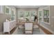 Elegant dining room with a wooden table, upholstered chairs, and natural light at 34 Macy Cir, Wendell, NC 27591