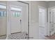Bright foyer featuring decorative tile flooring, white wainscoting, and an exterior door at 34 Macy Cir, Wendell, NC 27591