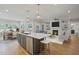 Open-concept kitchen featuring a large island, stainless steel appliances, and a connected living room at 34 Macy Cir, Wendell, NC 27591