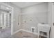 Functional laundry room with a utility sink, storage, and neutral finishes, offering practicality and efficiency at 34 Macy Cir, Wendell, NC 27591