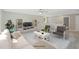 Bright living room with comfortable seating, TV, ceiling fan, and a view of the upstairs at 34 Macy Cir, Wendell, NC 27591