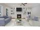 Cozy living room featuring a fireplace, built-in bookshelves, and comfortable seating at 34 Macy Cir, Wendell, NC 27591