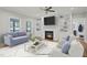 Comfortable living room with a fireplace, built-in bookshelves, and plush seating at 34 Macy Cir, Wendell, NC 27591