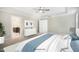 Bright main bedroom featuring a ceiling fan, ensuite bathroom, and walk in closet at 34 Macy Cir, Wendell, NC 27591