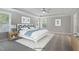 Relaxing main bedroom with tray ceiling, ceiling fan, and beautiful beach-themed decor at 34 Macy Cir, Wendell, NC 27591