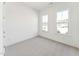 Bright bedroom with two windows and neutral carpet at 624 Gainer Dr # 17, Raleigh, NC 27610