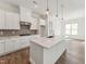 Modern kitchen featuring a central island with pendant lighting and stainless steel appliances at 624 Gainer Dr # 17, Raleigh, NC 27610