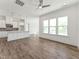Spacious living area featuring hardwood floors, a ceiling fan, and an open-concept layout with a kitchen at 624 Gainer Dr # 17, Raleigh, NC 27610