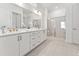 A luxurious bathroom with double sinks, quartz countertops, modern fixtures, and a glass-enclosed shower at 205 Mugby Rd # 173, Raleigh, NC 27610