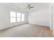 Bright bedroom with a ceiling fan, large window, and neutral carpet at 205 Mugby Rd # 173, Raleigh, NC 27610