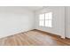 Bright bedroom featuring wood floors and a large window offering ample natural light at 205 Mugby Rd # 173, Raleigh, NC 27610