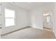 Bright bedroom with neutral carpet, white walls, and natural light from a window with an ensuite bathroom at 205 Mugby Rd # 173, Raleigh, NC 27610