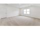 Neutral carpet in this bedroom with bright natural light coming through a window, white walls and trim at 205 Mugby Rd # 173, Raleigh, NC 27610
