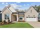 Charming brick home with a well-manicured lawn and a two-car garage, enhancing its curb appeal at 205 Mugby Rd # 173, Raleigh, NC 27610