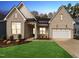 Charming brick home with a well-manicured lawn and a two-car garage, enhancing its curb appeal at 205 Mugby Rd # 173, Raleigh, NC 27610