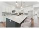 A bright kitchen features stainless steel appliances, an island with seating, and modern fixtures at 205 Mugby Rd # 173, Raleigh, NC 27610