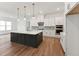 Well-lit kitchen featuring white cabinetry, a kitchen island, and stainless steel appliances at 205 Mugby Rd # 173, Raleigh, NC 27610