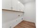 Laundry room with overhead cabinets and laminate floors at 205 Mugby Rd # 173, Raleigh, NC 27610
