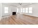 Spacious living room with a fireplace, ceiling fan, and large windows offering lots of natural light at 205 Mugby Rd # 173, Raleigh, NC 27610