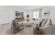 A cozy living room with a flat-screen TV, comfortable seating, and lots of natural light at 205 Mugby Rd # 173, Raleigh, NC 27610