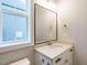 Well-lit bathroom featuring a large mirror, a vanity with double sinks, and modern fixtures at 100 Mossy Falls Way, Wendell, NC 27591