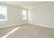 Spacious, carpeted bedroom featuring windows that offer plenty of natural light at 100 Mossy Falls Way, Wendell, NC 27591