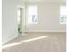 Bright bedroom with neutral carpet, white trim and two windows allowing natural light to fill the space at 100 Mossy Falls Way, Wendell, NC 27591