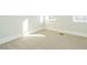 Bright bedroom with neutral carpet, white trim and two windows allowing natural light to fill the space at 100 Mossy Falls Way, Wendell, NC 27591