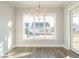 Dining area with a chandelier, large windows, and outdoor views at 100 Mossy Falls Way, Wendell, NC 27591