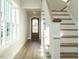 Entryway featuring hardwood floors, a wood door, and staircase with white risers at 100 Mossy Falls Way, Wendell, NC 27591