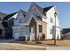 Charming two-story home featuring gray and white siding and landscaped front yard at 100 Mossy Falls Way, Wendell, NC 27591
