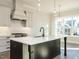 Modern kitchen featuring a center island with a black base and stainless steel appliances at 100 Mossy Falls Way, Wendell, NC 27591