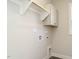 Laundry room features a storage cabinet, rod for hanging, and utility connections at 100 Mossy Falls Way, Wendell, NC 27591