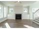 Open-concept living area with built-in shelving and black fireplace at 100 Mossy Falls Way, Wendell, NC 27591