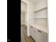 Bright pantry features gray cabinetry, light countertop, subway tile backsplash, and open shelving at 100 Mossy Falls Way, Wendell, NC 27591