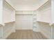 Bright, spacious walk-in closet with ample shelving and hanging storage at 100 Mossy Falls Way, Wendell, NC 27591