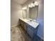Bathroom with double sinks, gray cabinets, modern fixtures and a bright, clean aesthetic at 216 Bruce Dr, Dunn, NC 28334