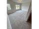 Bedroom with neutral carpet, paint, and trim, and a bright window that provides natural light at 216 Bruce Dr, Dunn, NC 28334