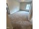 Cozy bedroom with neutral carpet, paint, and trim, and a bright window that provides natural light at 216 Bruce Dr, Dunn, NC 28334