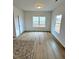 A bright dining room featuring wood-look floors, neutral paint, and large windows for plenty of natural light at 216 Bruce Dr, Dunn, NC 28334