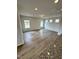 Spacious living room with wood-look floors, neutral paint, and large windows for plenty of natural light at 216 Bruce Dr, Dunn, NC 28334