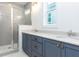 Bathroom featuring double sink vanity, modern fixtures, and glass enclosed shower at 1253 Barreto Dr, Wendell, NC 27591