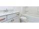 Bright bathroom featuring white vanity with gold hardware and a tub-shower combo with built-in shelving at 1253 Barreto Dr, Wendell, NC 27591