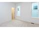 Bright bedroom featuring modern design elements, plush carpeting, and natural light from two windows at 1253 Barreto Dr, Wendell, NC 27591