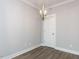 Neutral room featuring wood floors and a decorative modern chandelier at 1253 Barreto Dr, Wendell, NC 27591