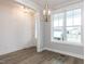 Bright dining room featuring wood floors and a modern chandelier at 1253 Barreto Dr, Wendell, NC 27591